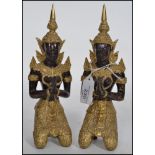 A pair of cold painted and gilded brass / bronze hindu deity's, both in the seated lotus position.