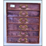 A set of vintage industrial factory table / desk top filing index cabinet drawers having a block opf