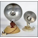 A pair of vintage / retro 20th century Barber heat lamps having a later conversion to lights