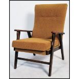 A 1950's fireside armchair having a chintzy gold upholstery raised on angular legs.