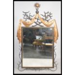 A large 20th cenury asiatic style mirror having a wrought ebonised metal frame with ornate copper