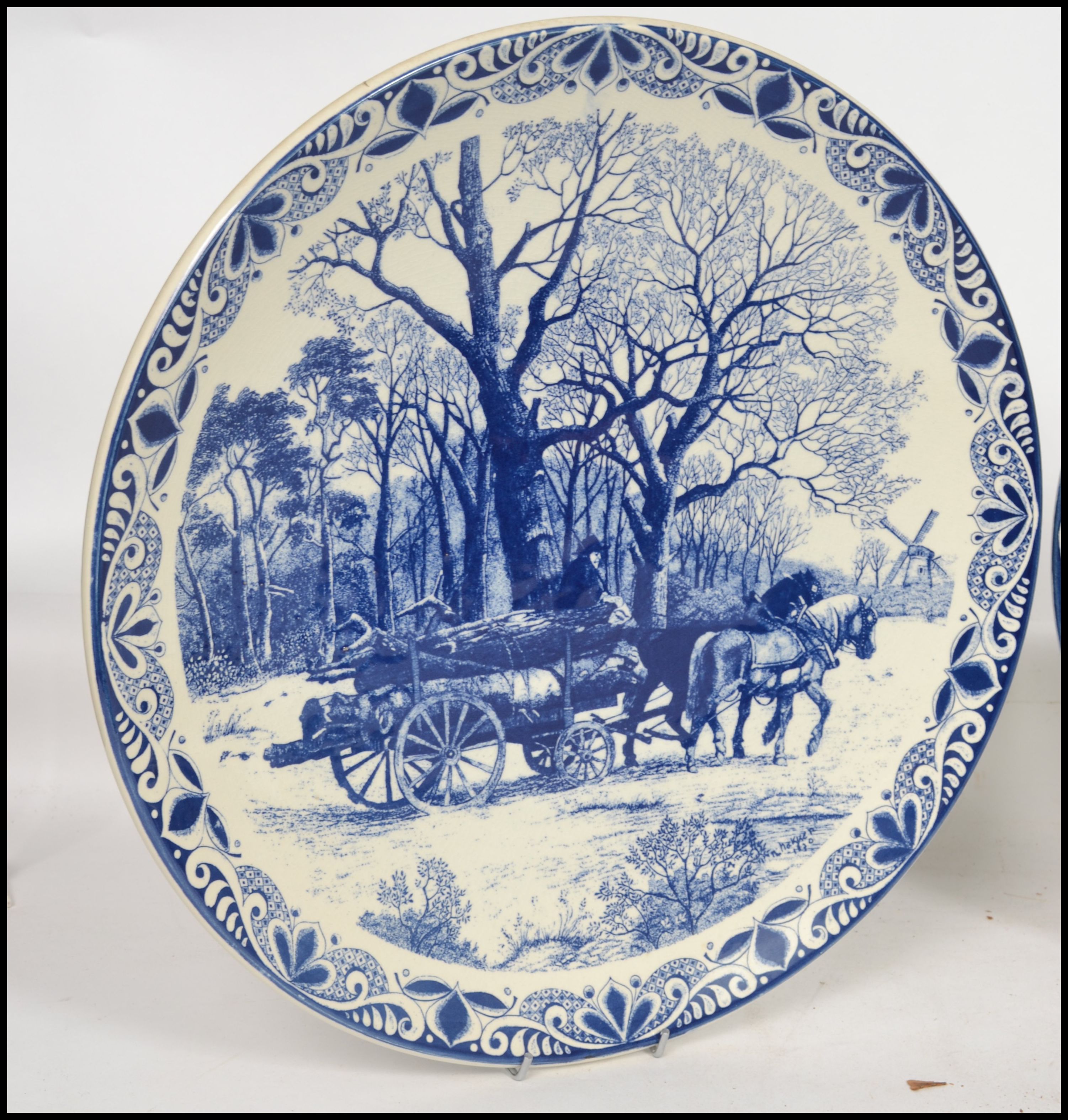 Two 20th century Delft ceramic wall hanging charger plates each having a central tondo depicting - Image 3 of 10