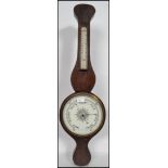 An early 20th century banjo barometer having a milk glass dial of circular form with thermometer