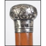 A continental hallmarked silver topped malacca walking stick / cane, with scroll work detail to