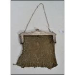 An Edwardian silver white metal mesh evening bag,  fine mesh work square bag below reticulated