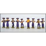 A 20th century retro vintage clay work South American nine piece marching band, the band playing