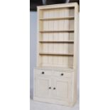 A contemporary 20th century painted pine dresser / bookcase cabinet. Having an open bookcase top
