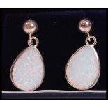 A pair of silver and opal ladies earrings, each of