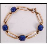 A 9ct gold / 375 and lapis Lazuli ladies bracelet being stamped Made in France to the gold lozenge