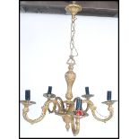 An early 20th century rococo / late baroque style 5 arm guilt gold chandelier having acanthus leaf