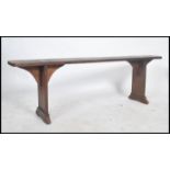 A   19th century French refectory pig bench. The bench with shaped single plant tops of fruitwood