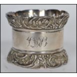 A large silver hallmarked napkin ring with plain b