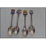 A group of four silver hallmarked and enamel spoon