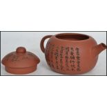 A terracotta Yixing teapot of squat globular form