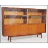 A vintage 20th century retro danish influence G-Plan style teak wood display cabinet raised on