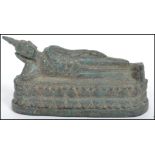 A 19th century bronze Buddha modelled in a reclined position raised on a oval plinth base.