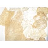 A collection of lace work dating from the 19th century to include table cloths, doilies etc please