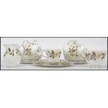 A Wedgwood Bone China seven person tea service in a floral design, to include cups, saucers.