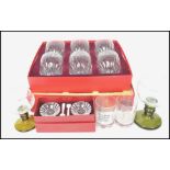 A boxed set of Baccarat crystal glass whisky tumblers together with a boxed pair of Baccarat crystal