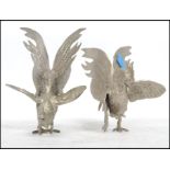 A vintage 20th century pair of large silver plate fighting cocks - cockerels, both in differing