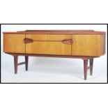 A 1970's gallery backed teak sideboard having two unusual recessed ovoid shapes which make up the