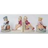 A pair of Victorian ceramic novelty bookends having children pushing and pulling along with a pair