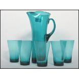 A stunning hand made retro lemonade set in a turquoise glass consisting of a tall lemonade jug
