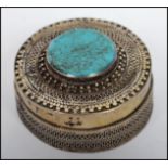A vintage Kazakhstan silver gilt and Turquoise snuff box from Russian central Asia of circular form,