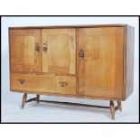 A mid century Ercol Windsor pattern sideboard dresser. Light elm and beech sideboard, double doors