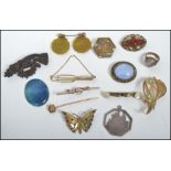 A collection of vintage 19th and 20th century jewellery to include a Ruskin brooch, a 9ct gold pin