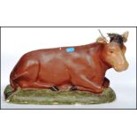 A vintage retro 20th century advertising point of sale agricultural model of a cow moulded in a