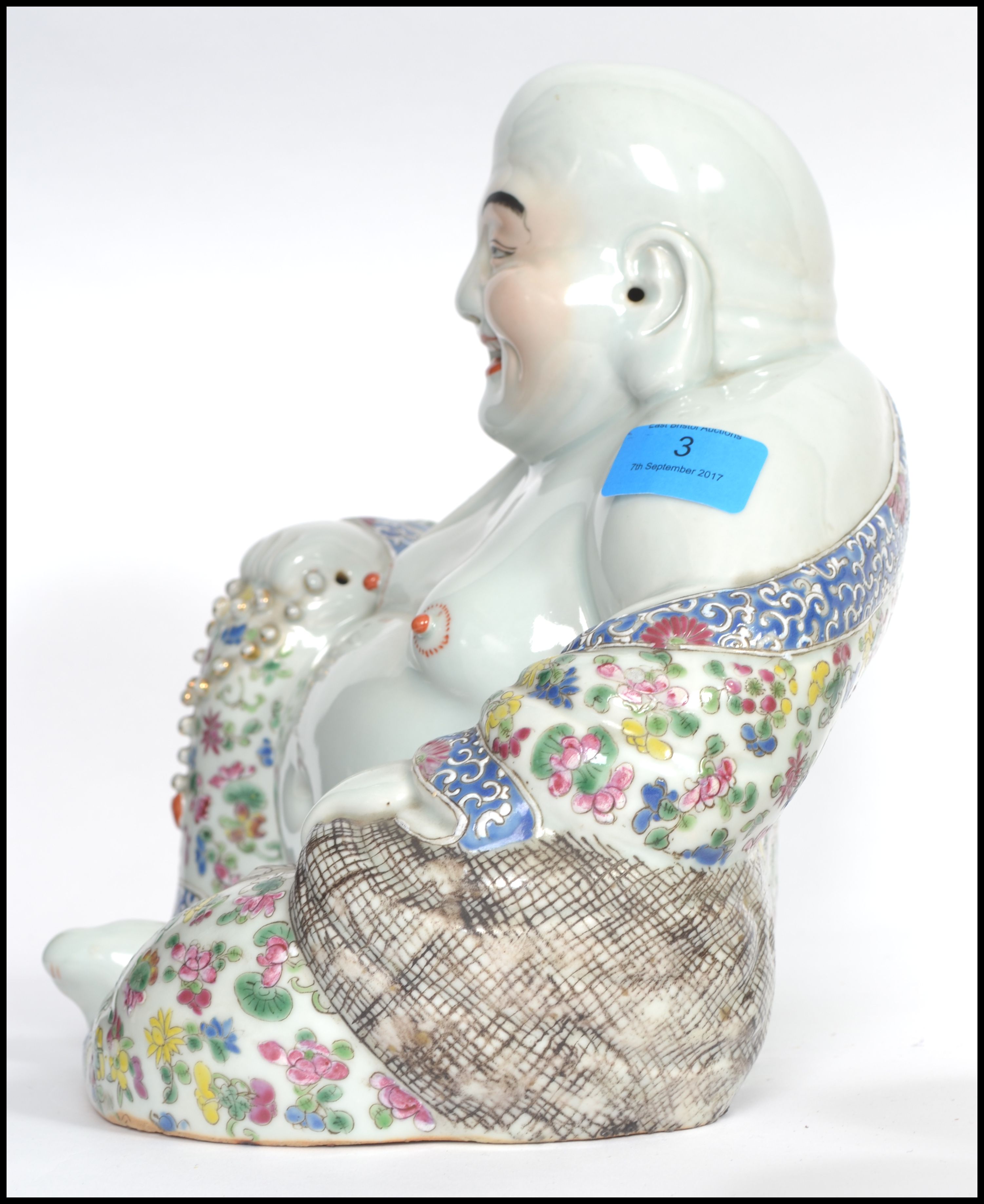 An Oriental ceramic large seated laughing Buddha decorated in famille rose patterned robes holding - Image 5 of 8