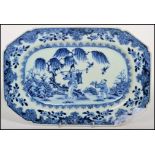 A 19th century Chinese blue and white ceramic charger decorated with stylised border and a central