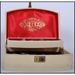 A vintage cream and gilt jewellery box with lock to front opening to reveal a collection of