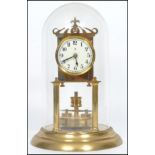 A 20th century glass domed brass anniversary clock raised on a stepped circular base with twin