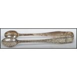 A pair of  silver hallmarked sugar tongs dating to the 19th century Victorian period. London