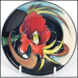 A Moorcroft Trial Piece ceramic tube lined coaster pin dish decorated in The Satin-flower pattern on