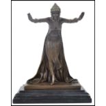 A good 20th century Art Deco bronze figurine of an arabic / dancing girl deity being raised on a