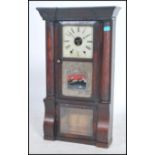 A large 19th century American Gingerbread clock with a rectangular walnut upright gase having
