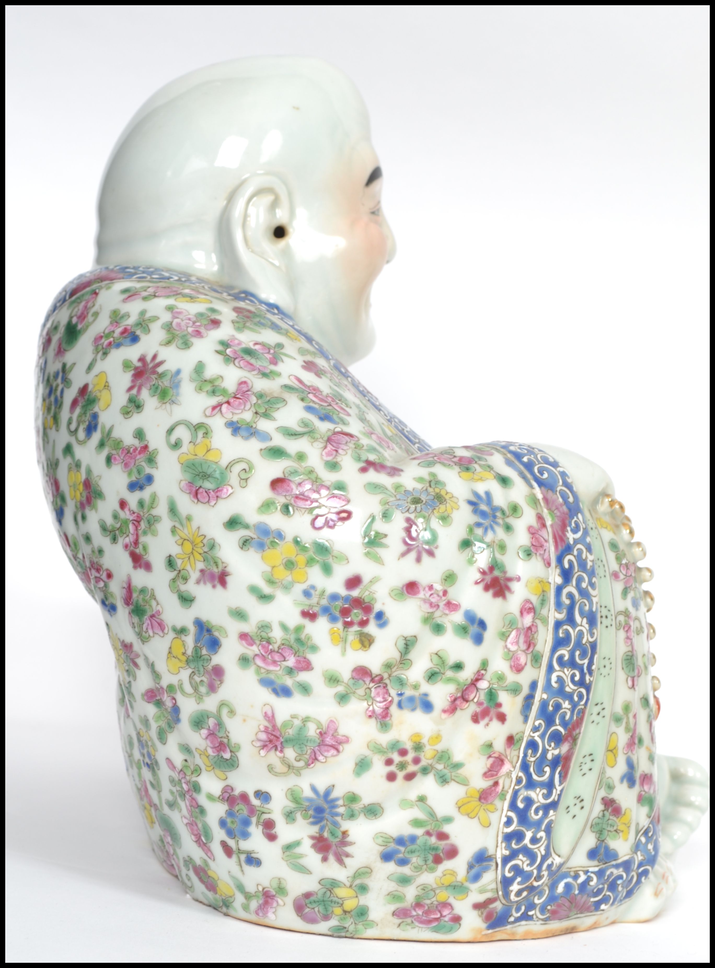 An Oriental ceramic large seated laughing Buddha decorated in famille rose patterned robes holding - Image 7 of 8