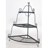 A 20th century ebonised metal waterfall florists display stand of half moon form. Each tier with