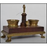 A 19th century Napoleon inspired French desk stand, raised on a set of four ormolu lion pad feet