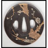 A good bronze Japanese Tsuba being signed and cast in relief with coloured metals ( see