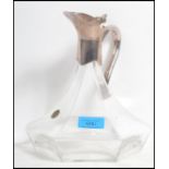 A 20th century silver plated and crystal glass claret jug of hexagonal form having faceted glass