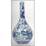 A 19th century Kang-xi blue and white vase being decorated with 5 claw dragons with fireballs and