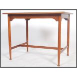 A teak Danish inspired table of small proportions raised on turned legs and pad feet united by a H