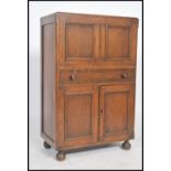 A vintage 20th century 1950's full front oak cocktail cabinet bar with mirror to back, lemon