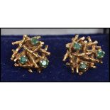 A pair of 9ct gold and emerald stud back earrings in the form of birds nests and each nest having