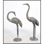 A pair of decorative 20th century cast brass garden ornaments, each in the form of asiatic cranes.