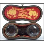 A pair of early 20th century brass opera glasses by Negretti & Zambra, having faceted leather